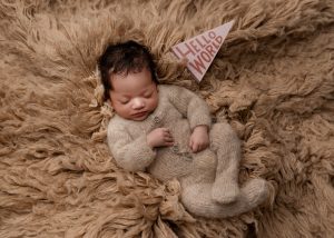 Newborn baby posed on a soft cream blanket in a Charleston newborn photography studio.